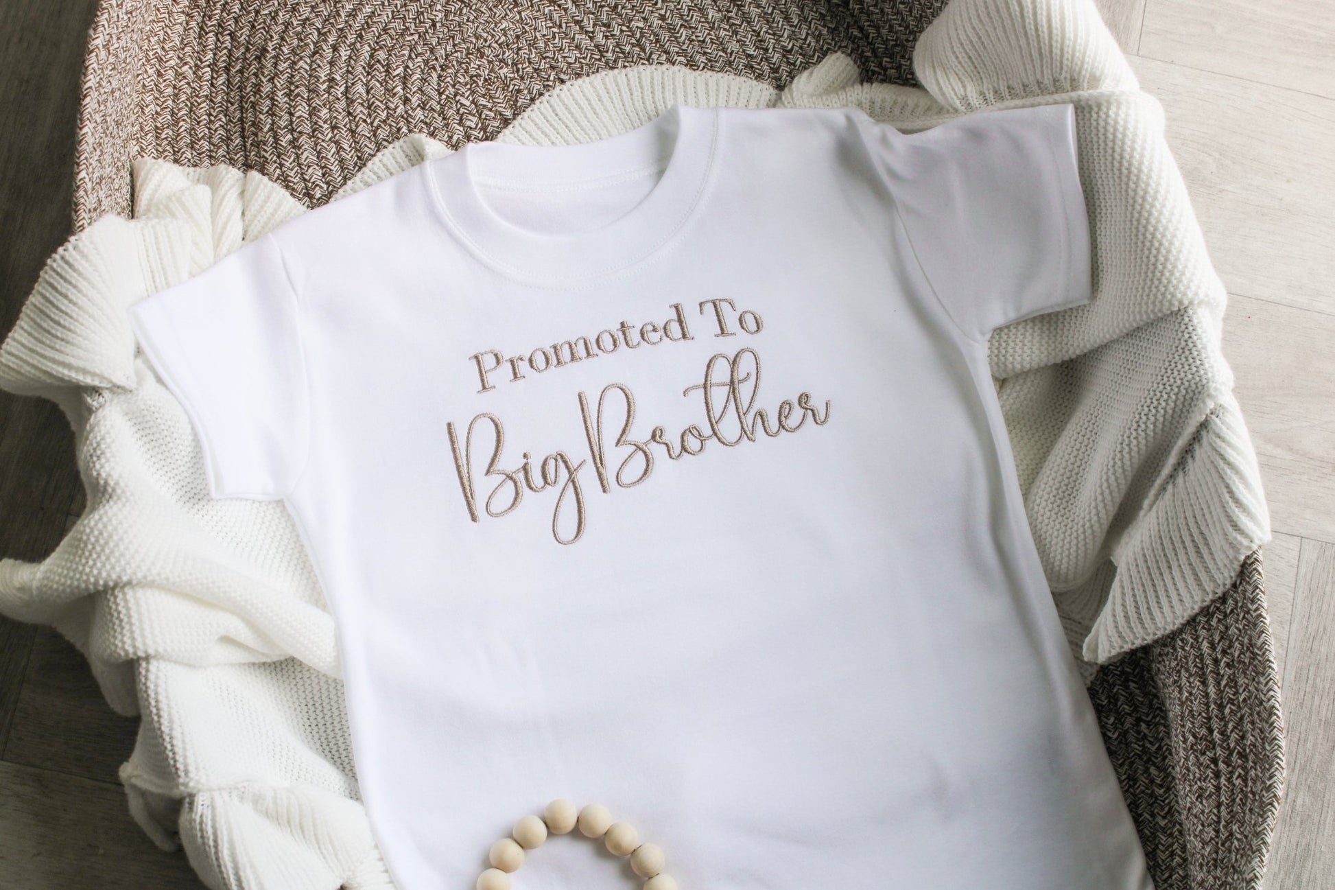 Children's t-shirt displaying 'promoted to big brother' across the chest