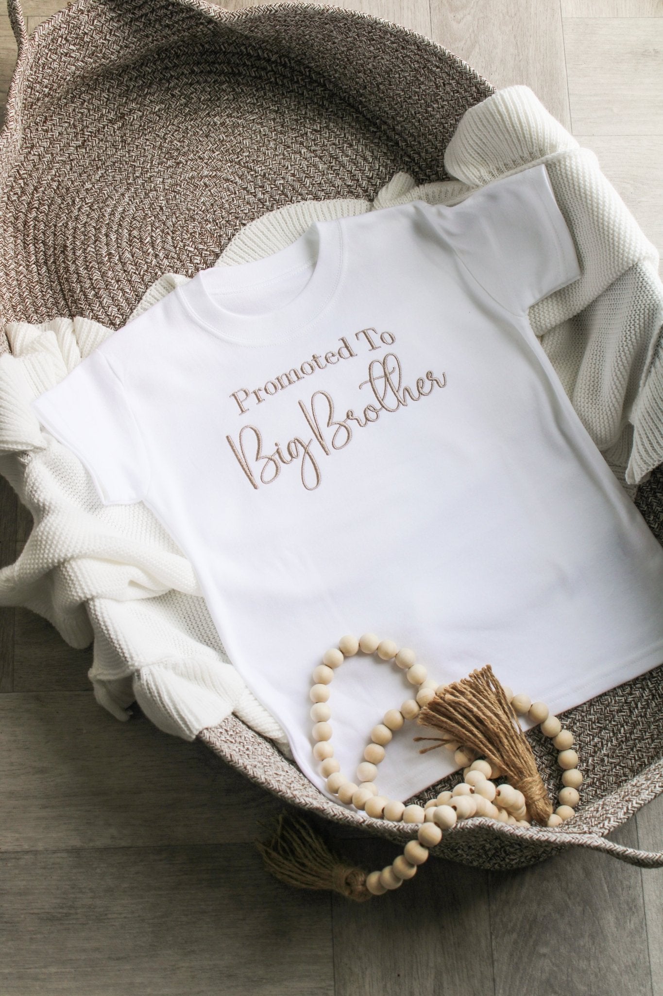 Neutral soft brown 'big brother' font on a thick white tshirt