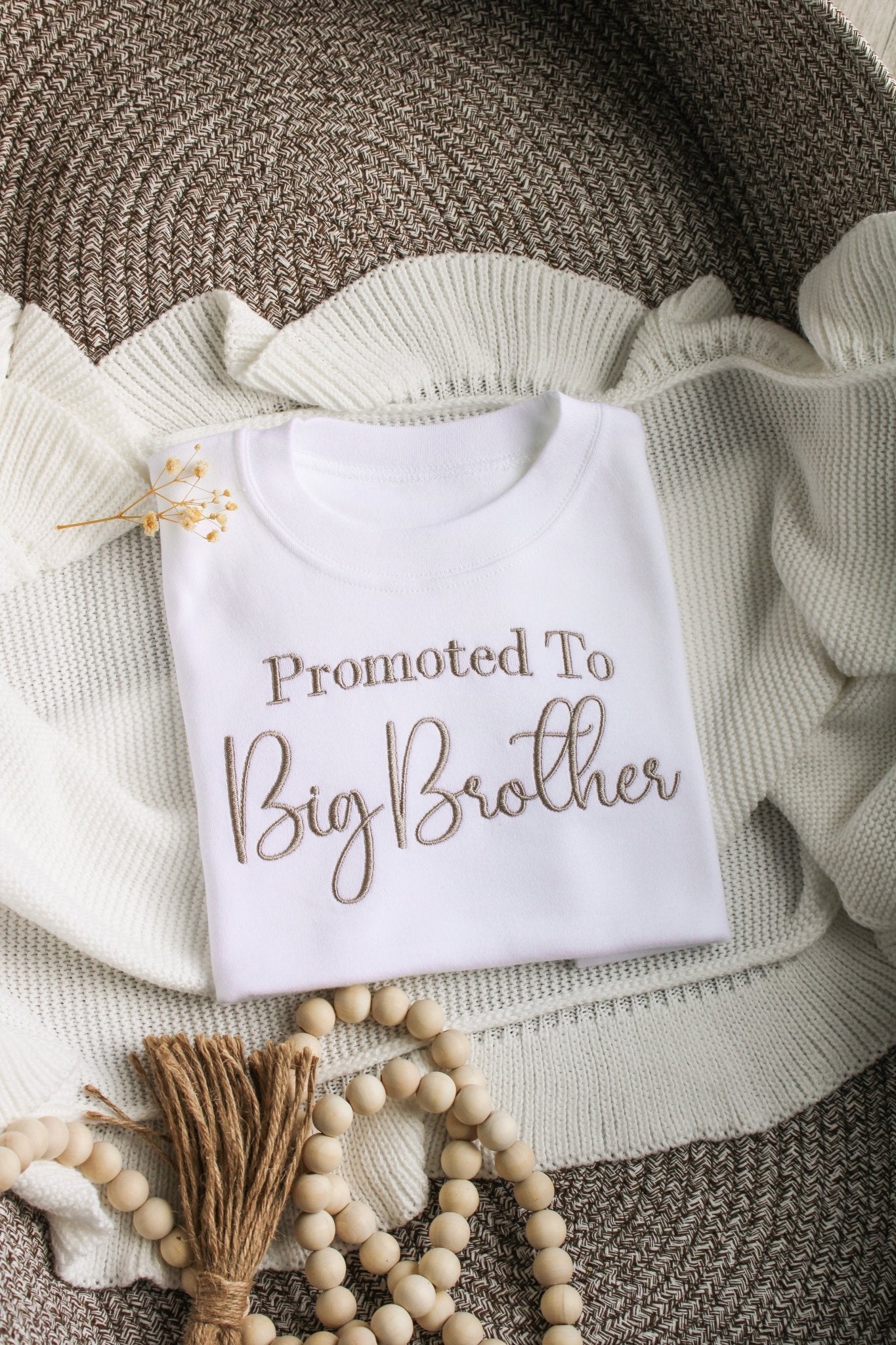 Beautifully embroidered white top with the phrase 'promoted to big brother'